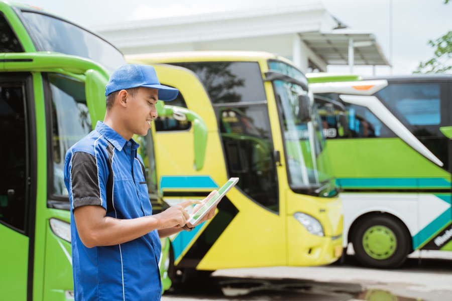Bus fleet worker using a tablet